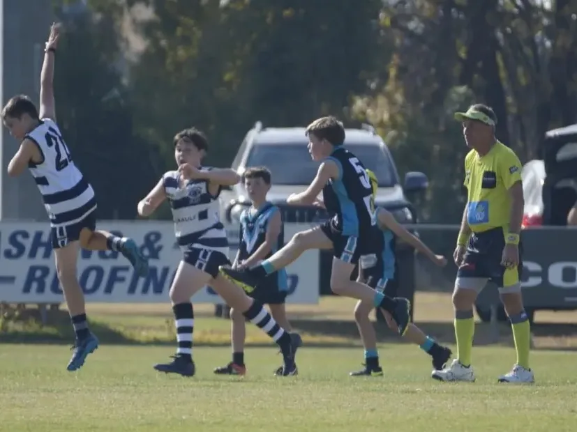 Junior football at Dookie United — players contesting the ball mid-kick on match day